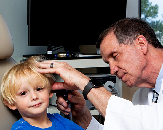 Dr checking the ears of a patient