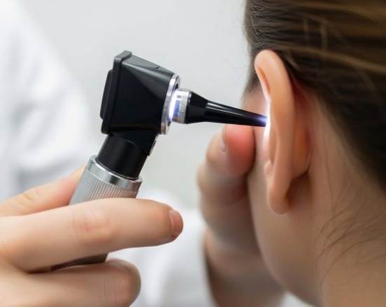 ENT doctor looking into a patient's ear