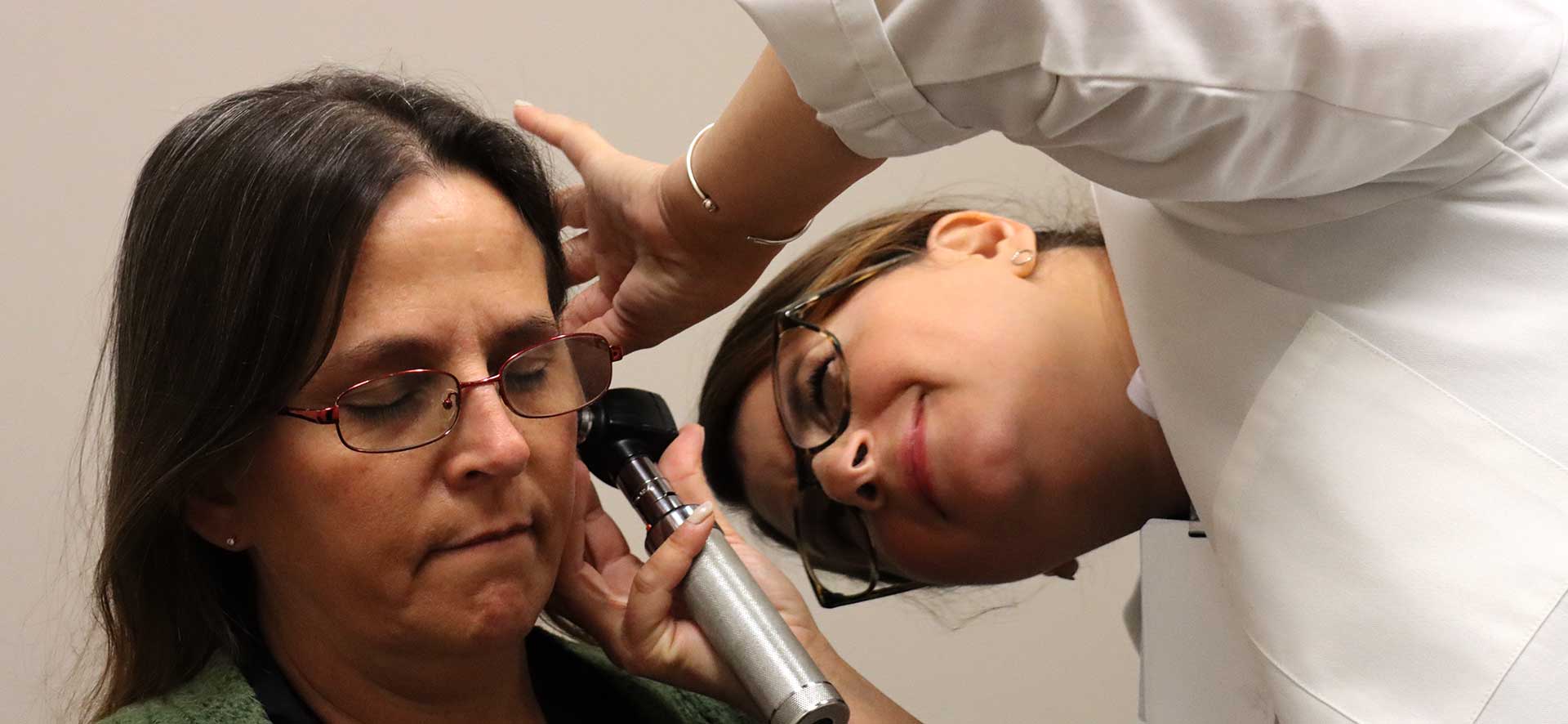 Dr checking the ears of a patient